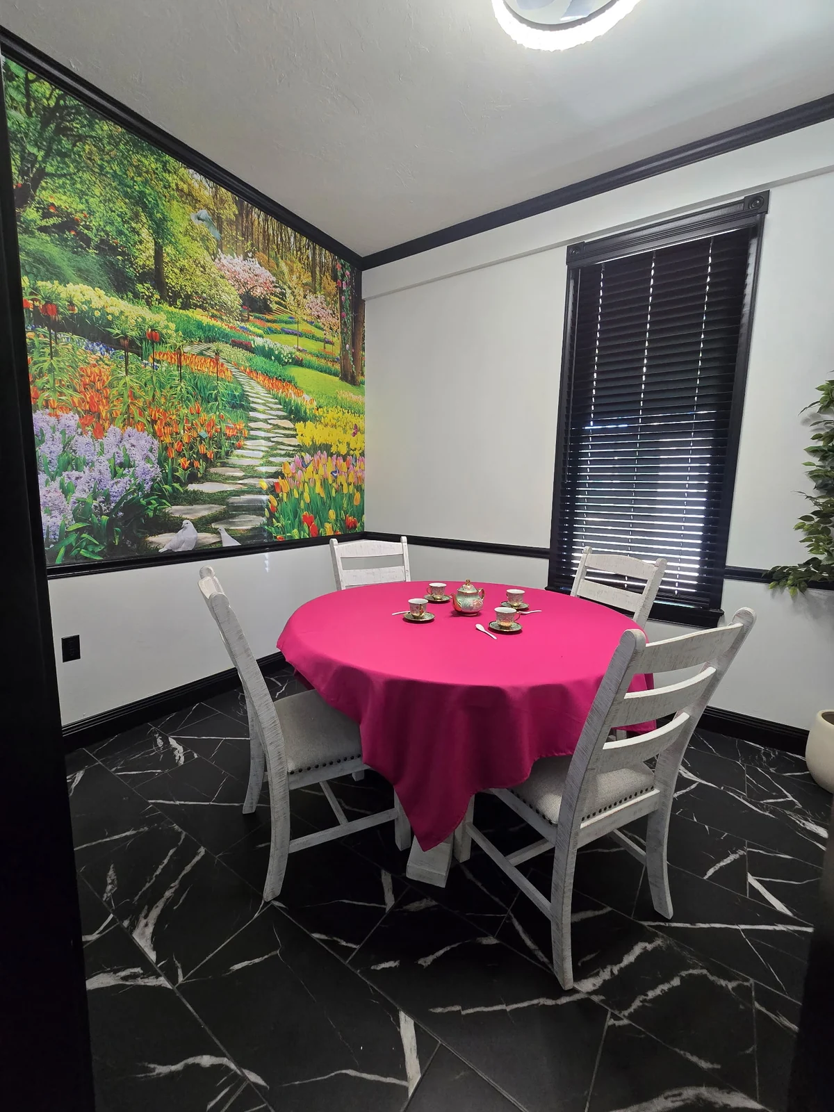 A small private room set with a pink tablecloth
