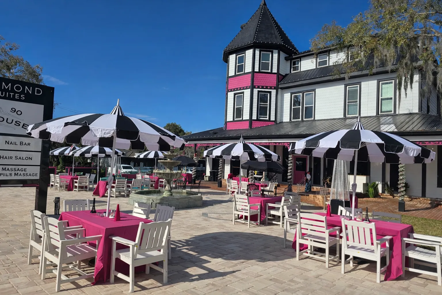 The black, white, and pink 1890 Tea House with its outdoor patio