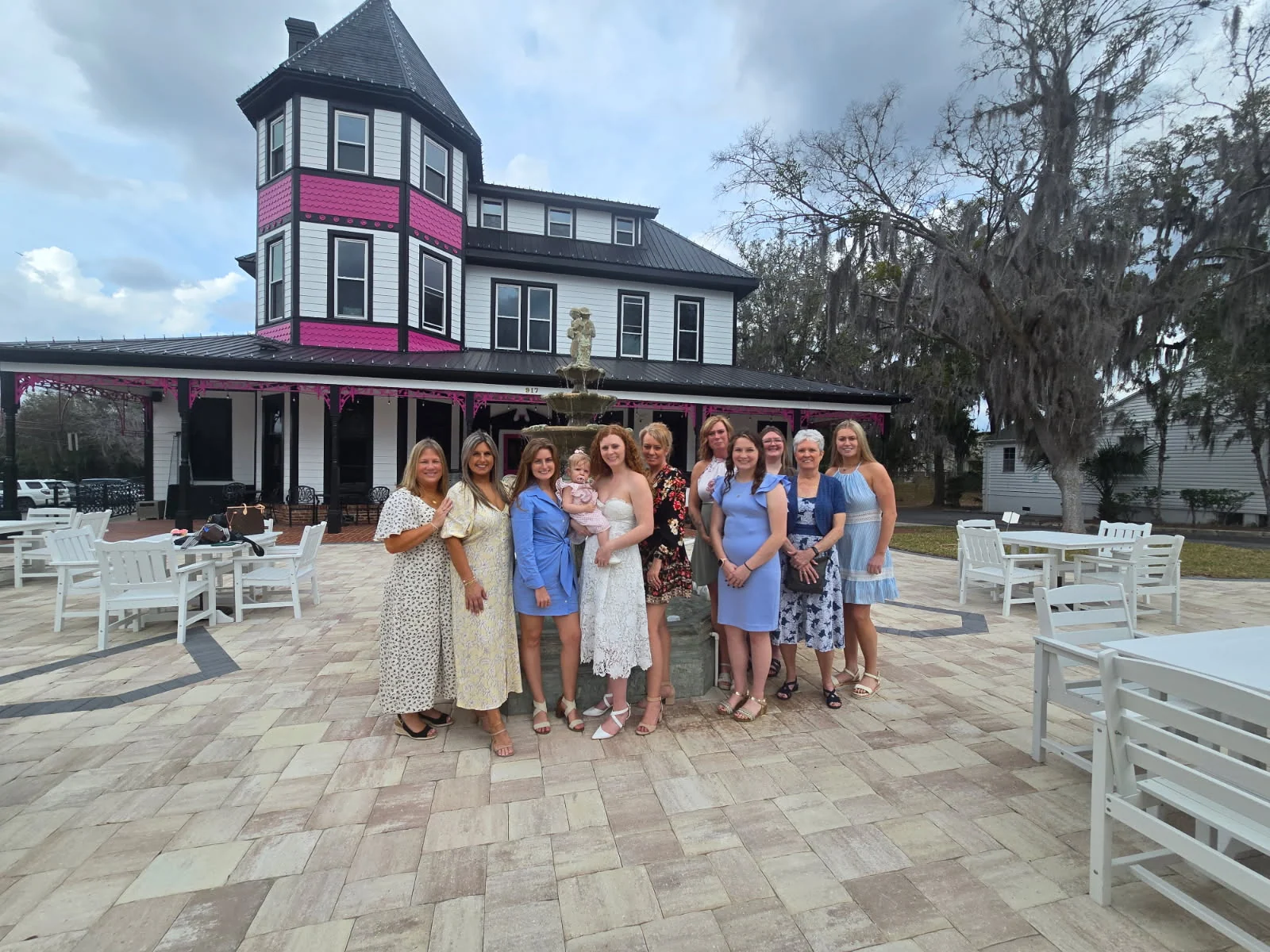 A bridal party gathered outside the historic Tea House