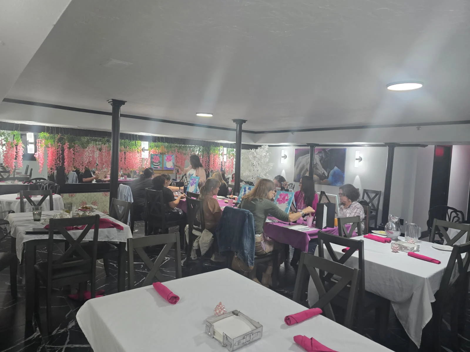 Guests enjoying a group painting party