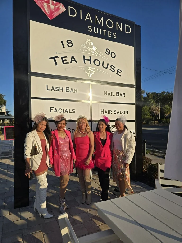 Guests dressed in pink and black outside 1890 Tea House