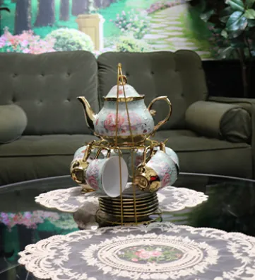 A floral tea service arranged on a gold stand