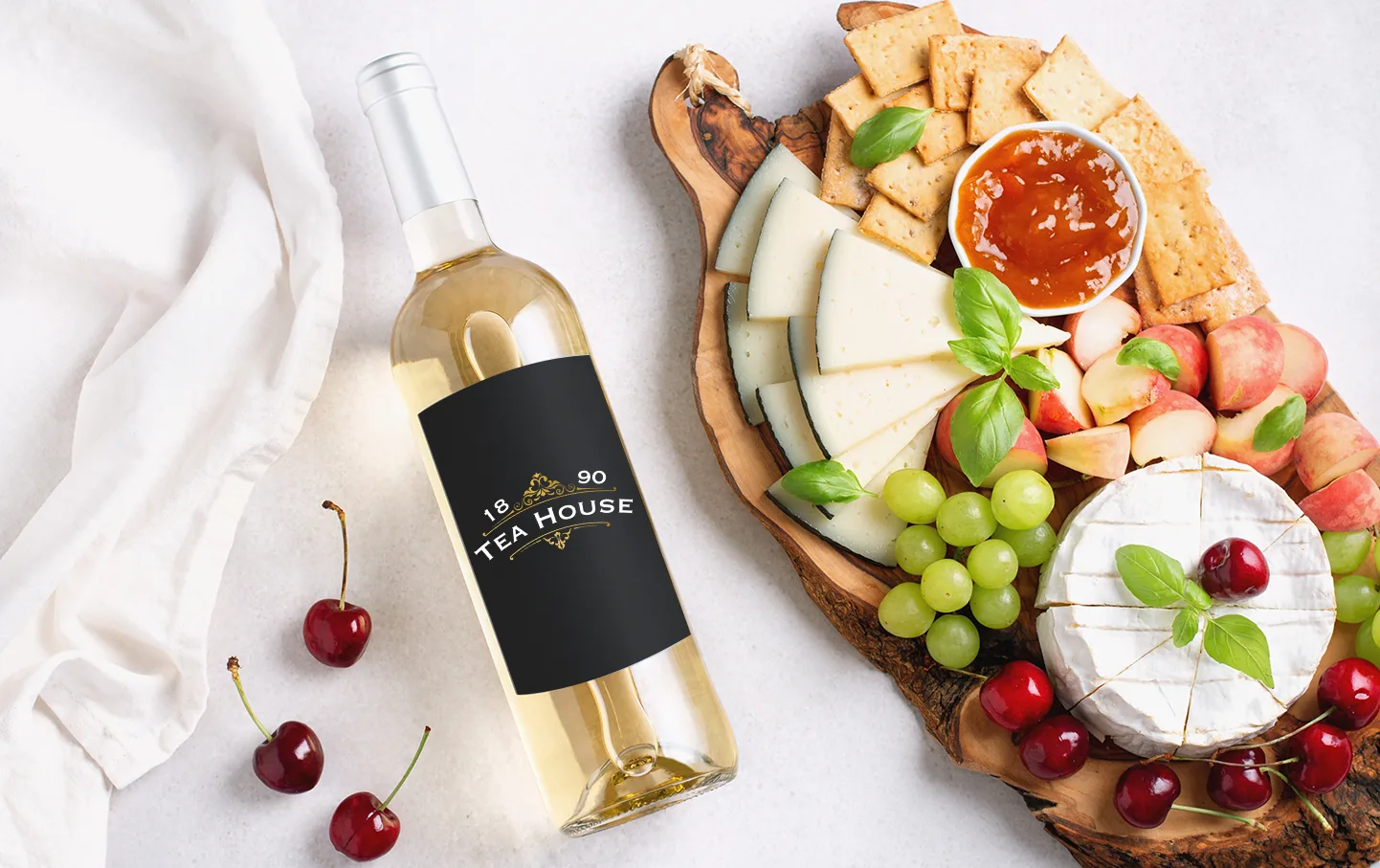 Wine and a charcuterie board arranged on a light table